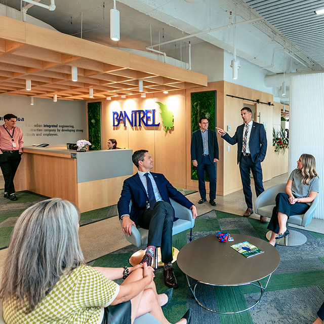 Diverse group of employees, gathered at a boardroom table