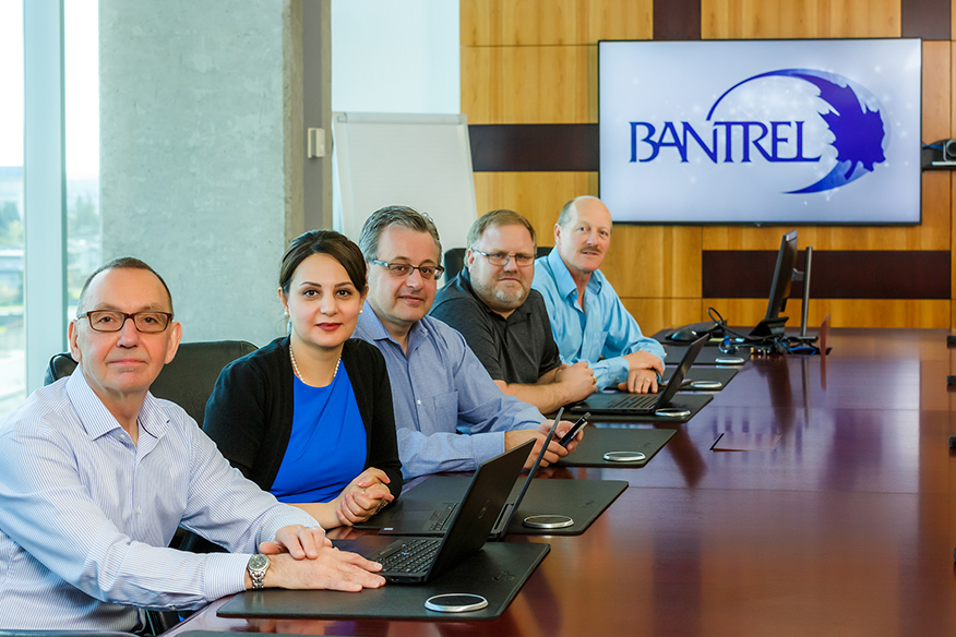 Diverse group of employees, gathered at a boardroom table